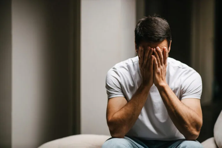A young man with head in his hands